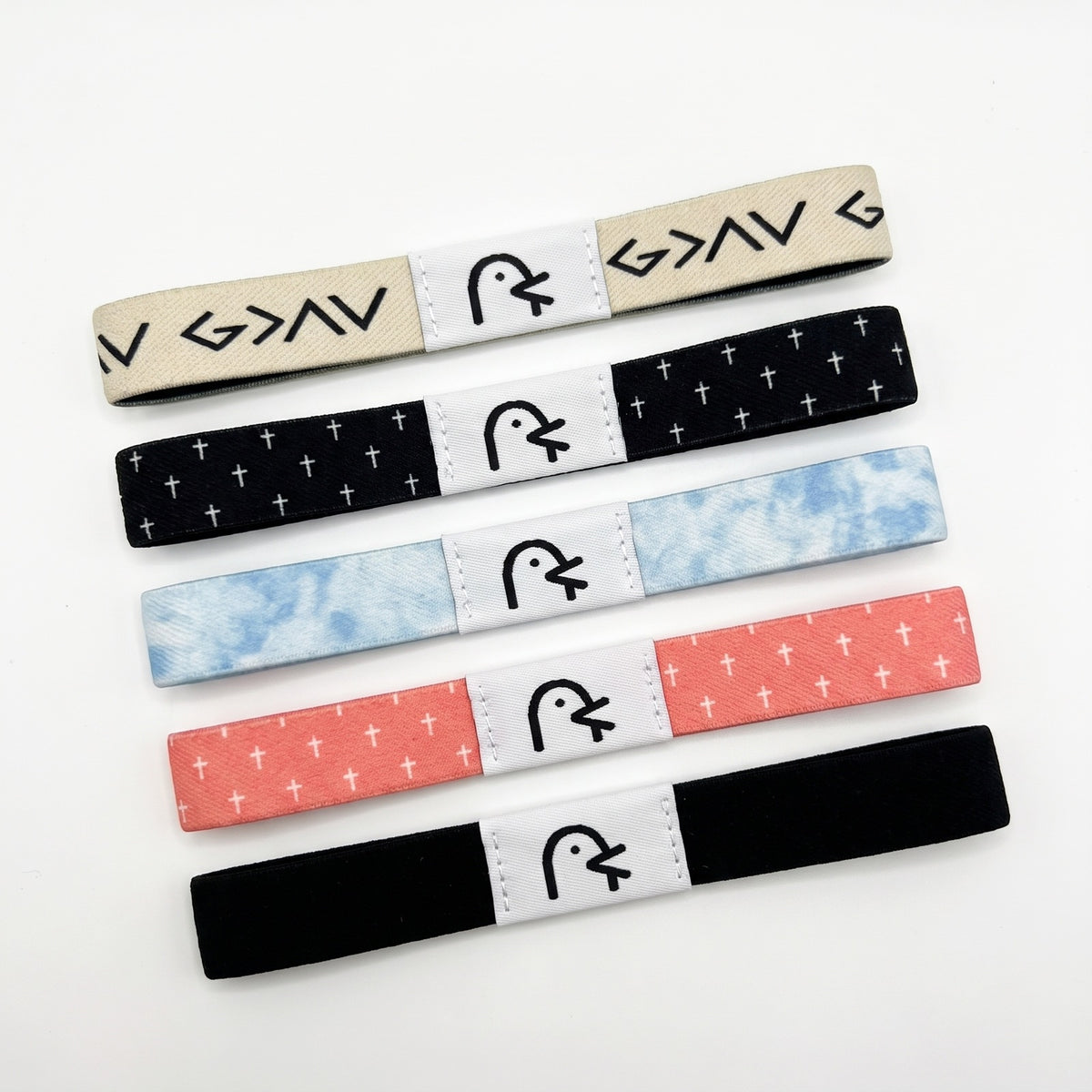 The five Daily Verse bands on their pattern sides, each with its white label: God Is Greater, Jesus Is King, Faith Over Fear, Love Like Jesus and Armor Of God