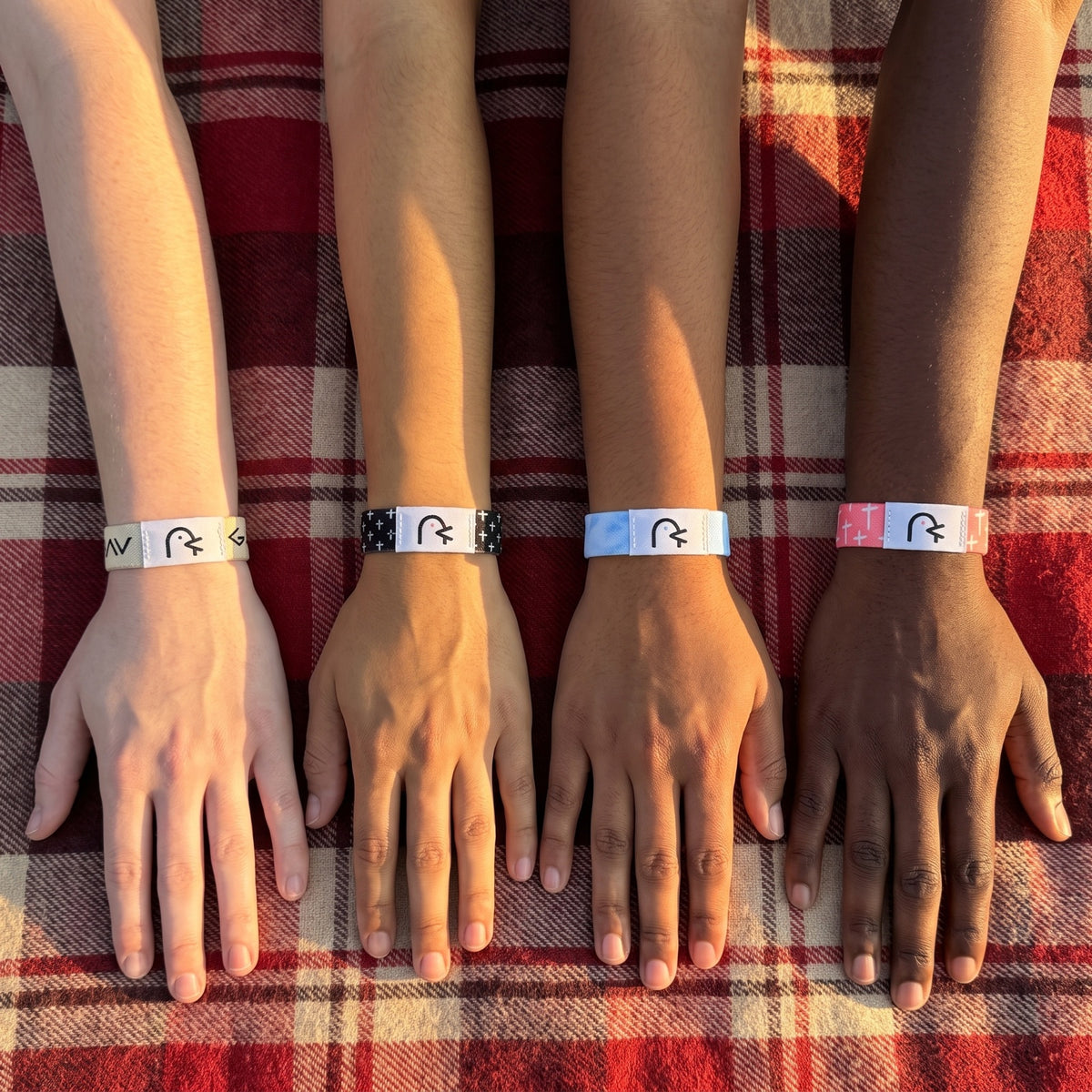 Four friends' wrists side by side, each wearing a Daily Verse band