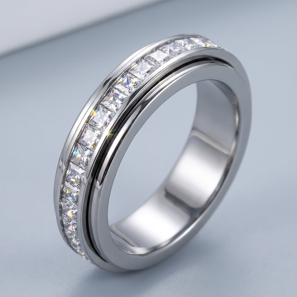 Calm Spinner Ring – close-up of the channel-set CZ stones and polished rails
