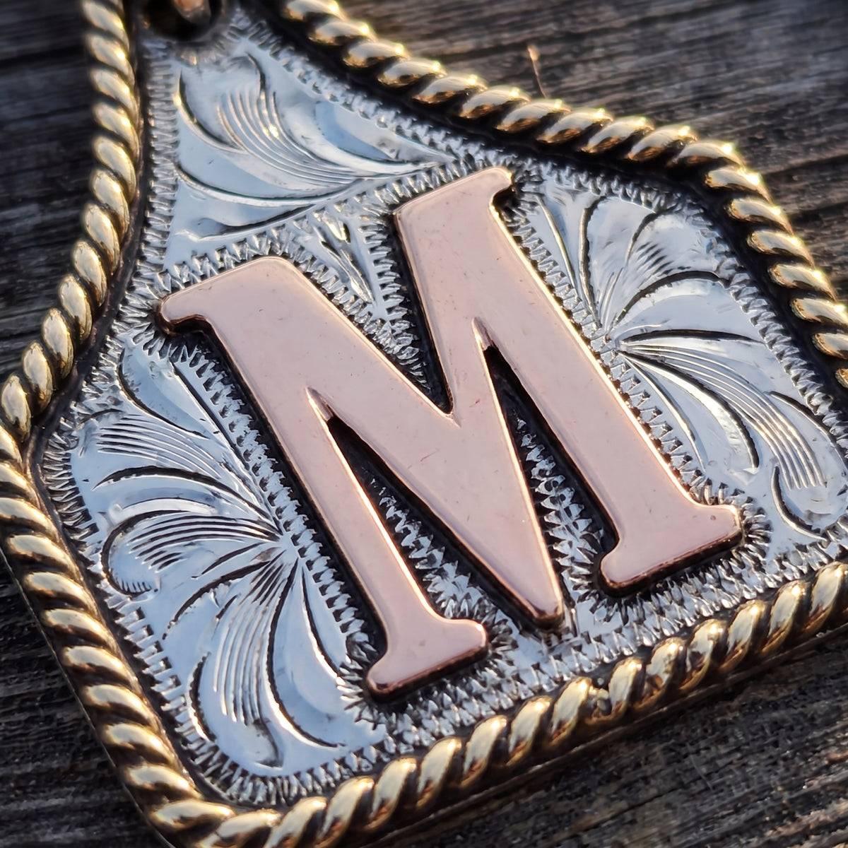 Cow Tag Initial Necklace & Keychain – macro of the hand engraving, twisted gold rope border and raised copper letter M