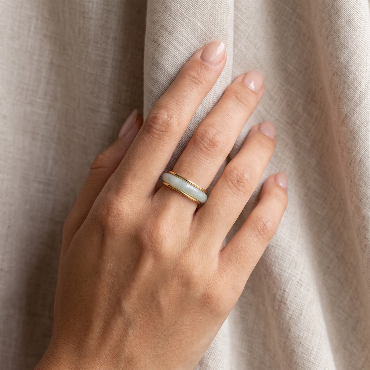 Jade Stacking Ring – worn on the hand, stacked between two thin gold bands
