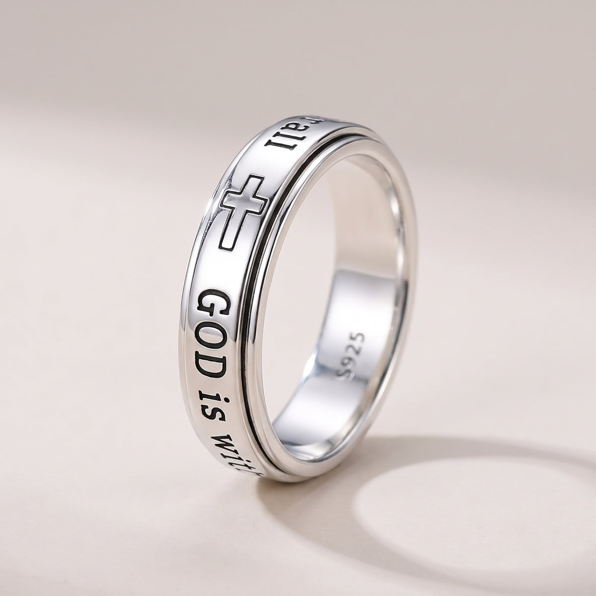 Psalm 46:5 Spinner Ring – sterling silver spinner ring engraved with a cross and "GOD is within her" on a warm grey background
