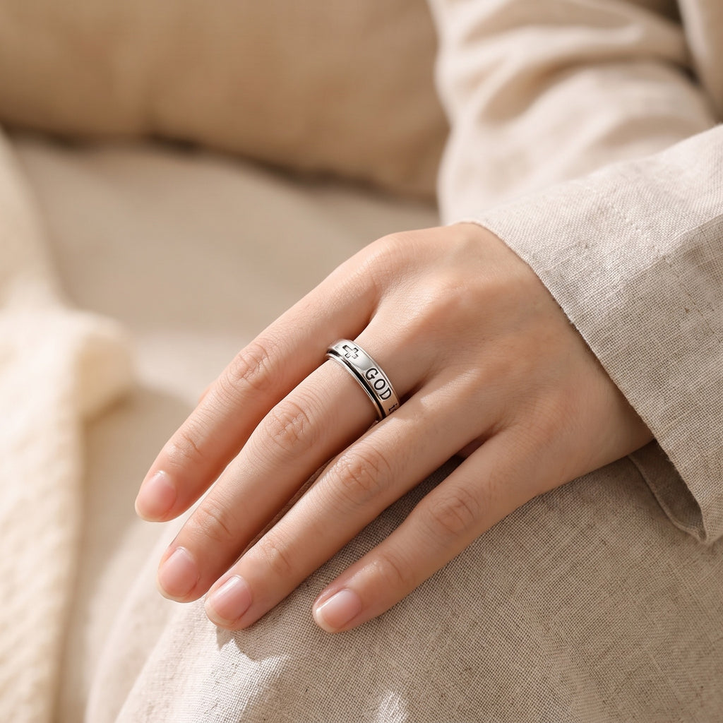 Psalm 46:5 Spinner Ring – worn on a woman's ring finger in soft window light