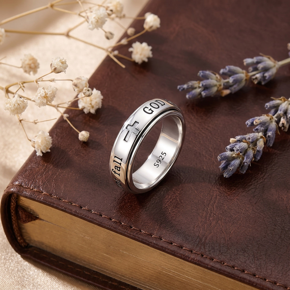 Psalm 46:5 Spinner Ring – resting on a closed leather Bible with dried flowers